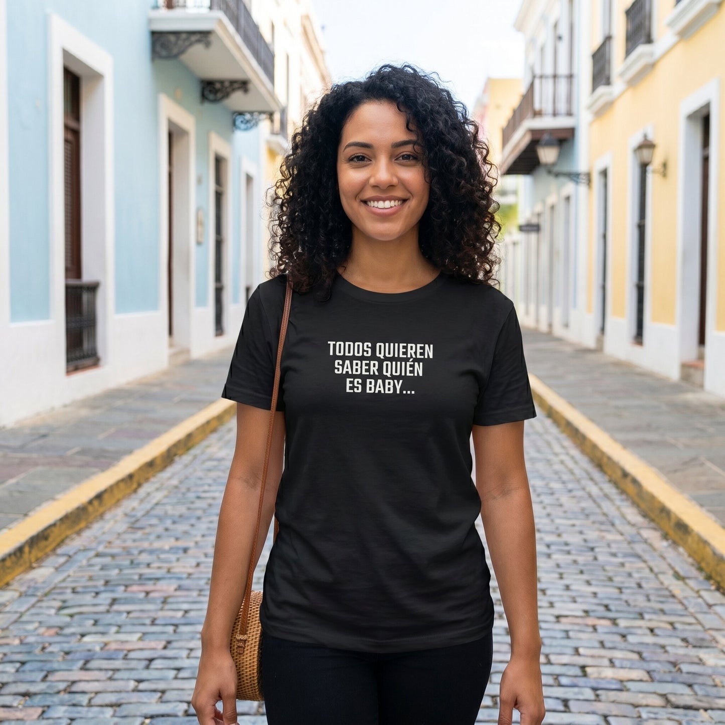 Woman wearing Quién es Baby bilingual black tee — unisex fit, Puerto Rico streetwear designed by Abimael Medina.