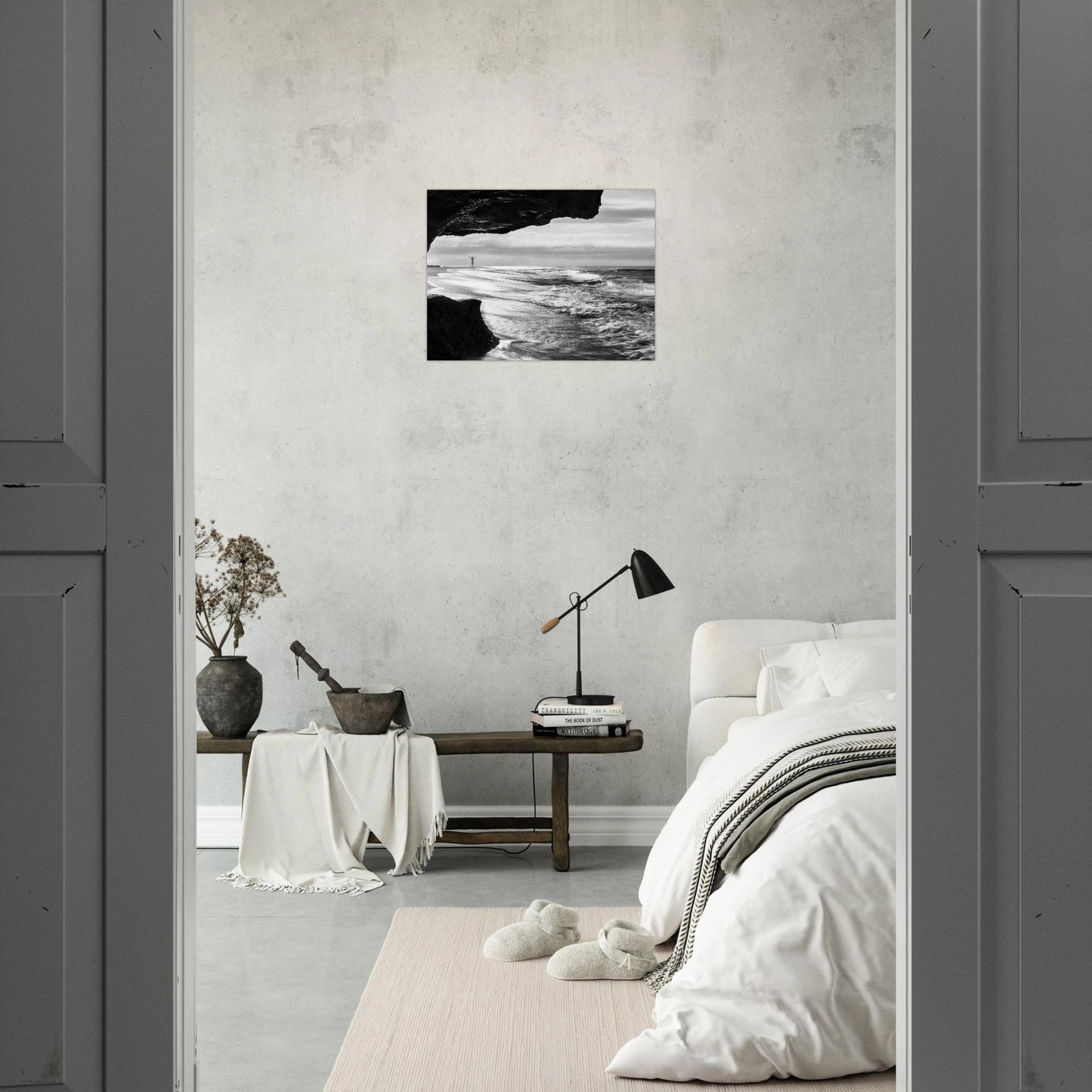 Libre B&W fine art print — bedroom wall mockup, lone figure sea cave Aguadilla Puerto Rico.