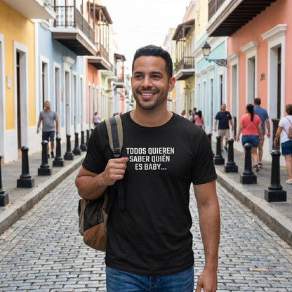 Person wearing black Puerto Rico political streetwear tee reading 'Todos quieren saber quién es Baby' in Old San Juan — wearable journalism designed by Abimael Medina.