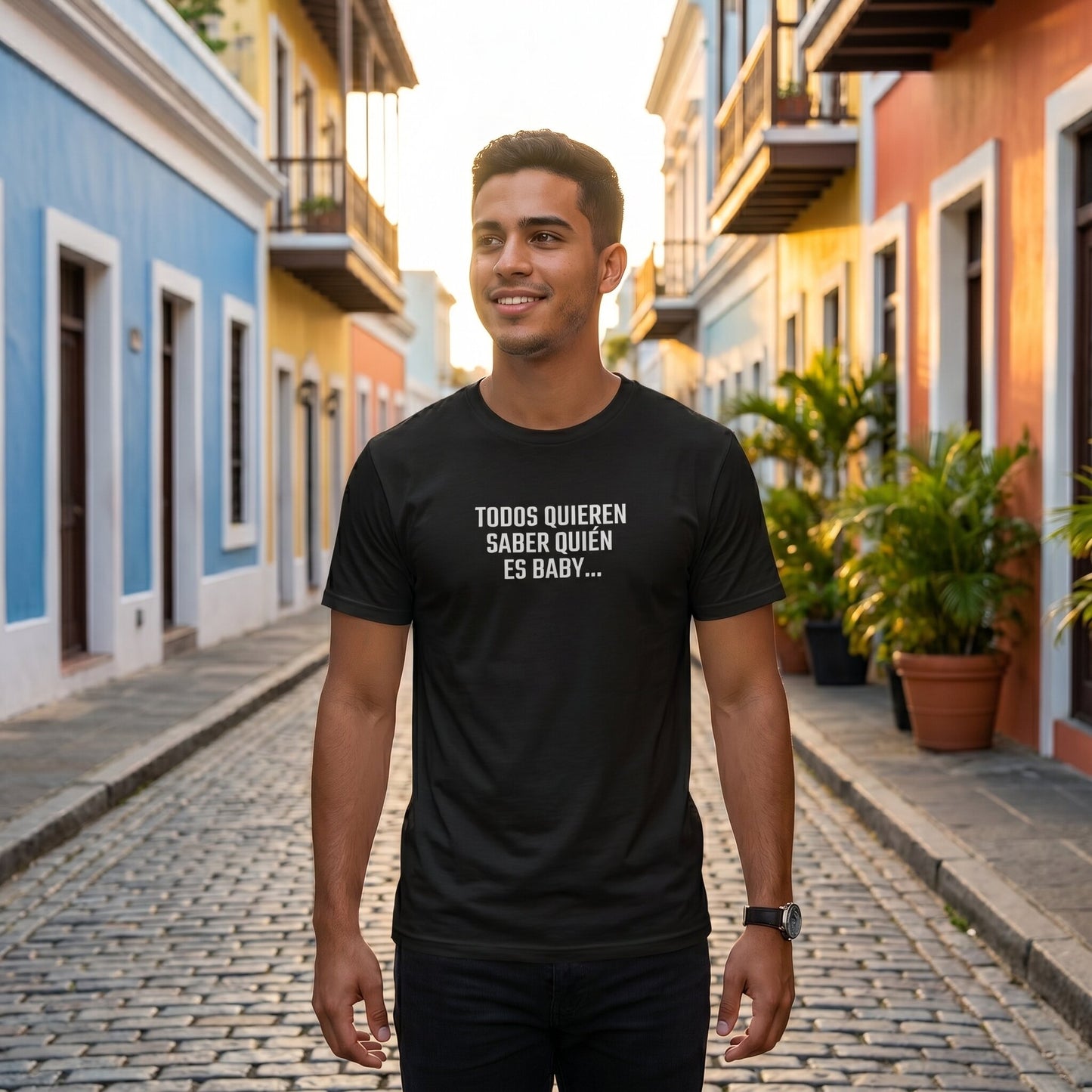 Man wearing Quién es Baby black tee in colorful street setting — Puerto Rico streetwear, designed by Abimael Medina.