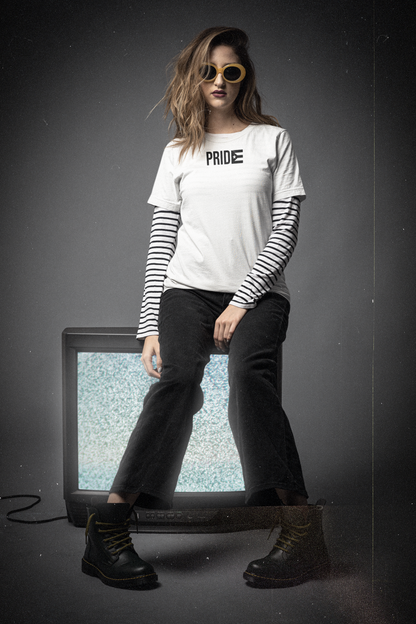 Editorial photo of a woman in a white PRIDE Boricua La Resistencia tee with the black Puerto Rican flag, retro 90s aesthetic — Boricua queer pride and resistance streetwear, designed in Puerto Rico.